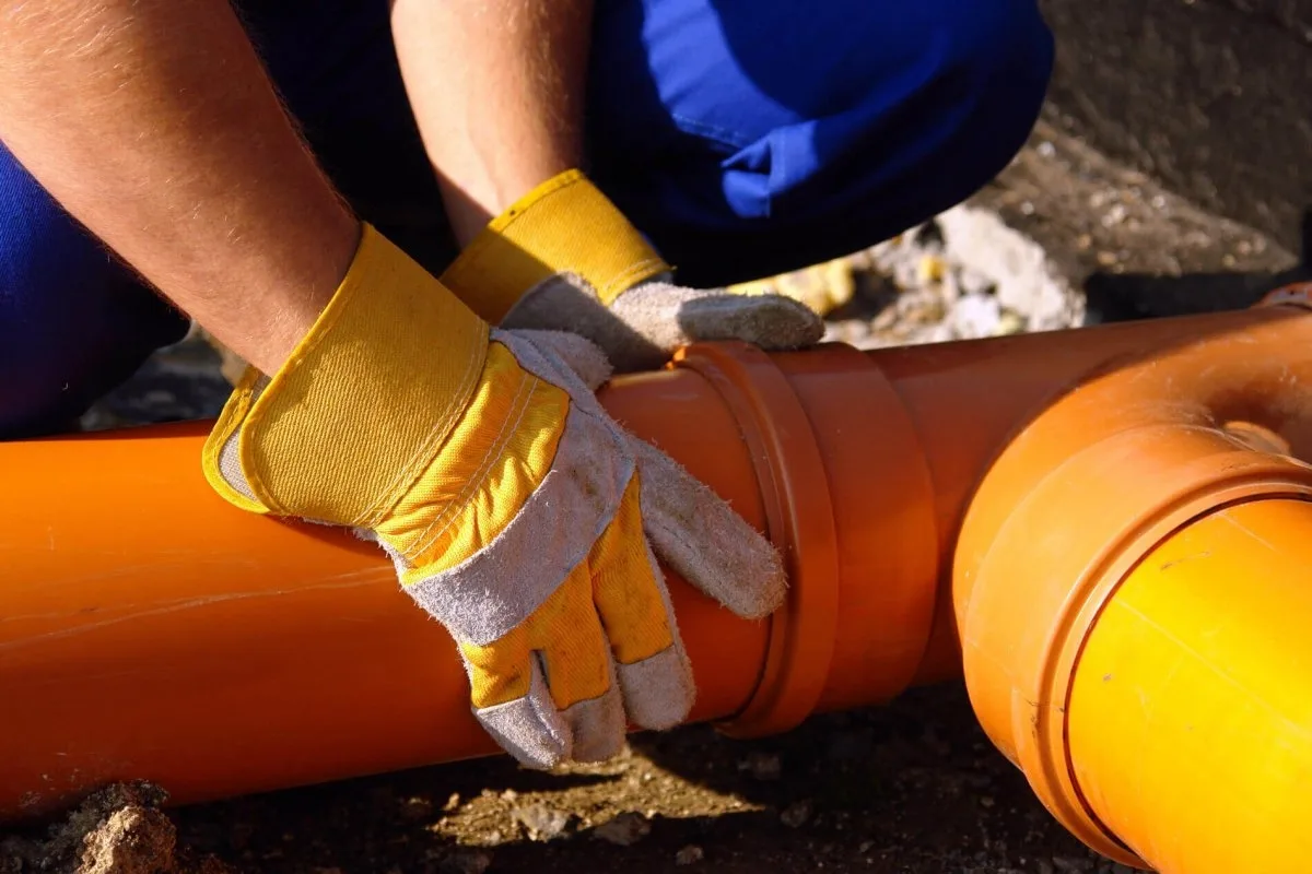 Technician locating an underground sewer line