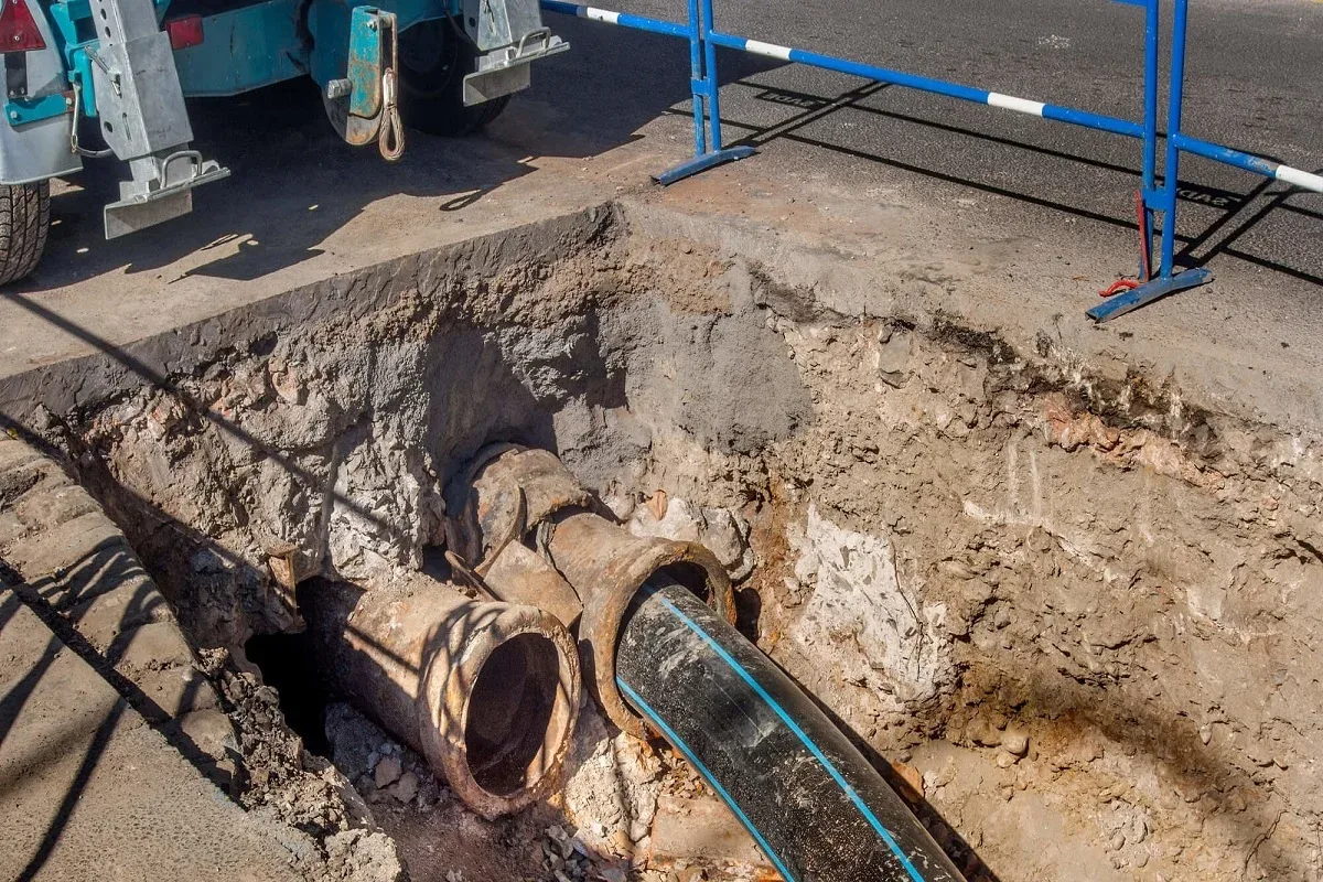 Plumber repairing a sewer pipe