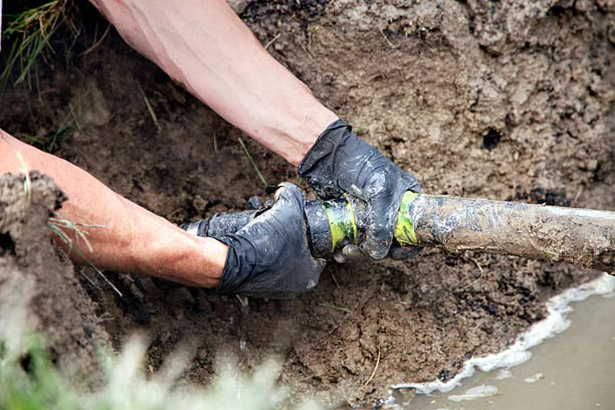 Plumber repairing a residential water line